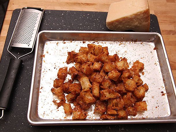 Golden baked garlic croutons on a sheet pan for Caesar salad.