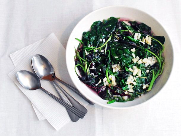 A bowl of spinach and red shen choy in garlicky broth.