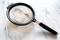 KitchenAid Classic Strainer with flour on a marble surface