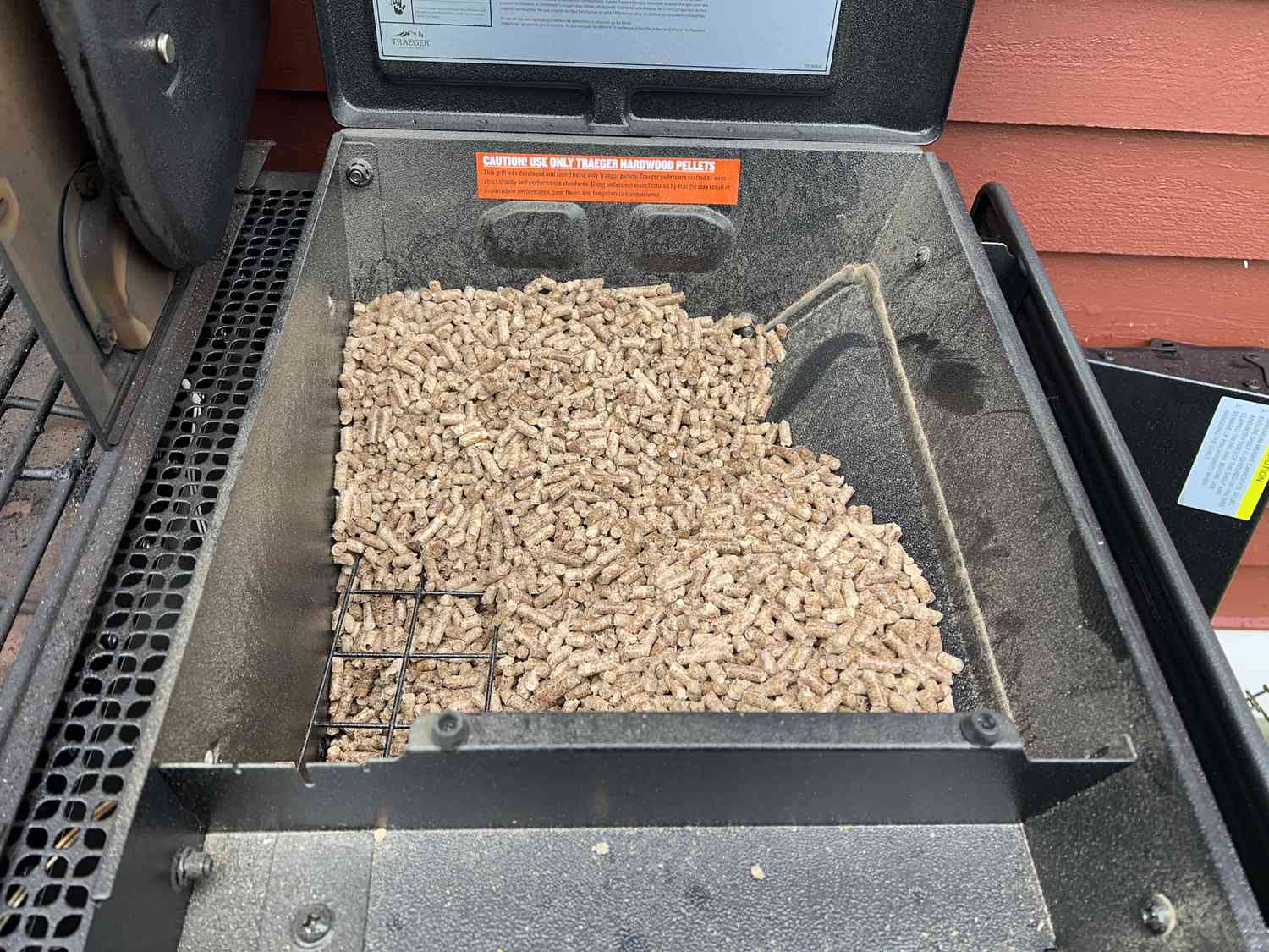 The wood pellet hopper of the Traeger Woodridge grill