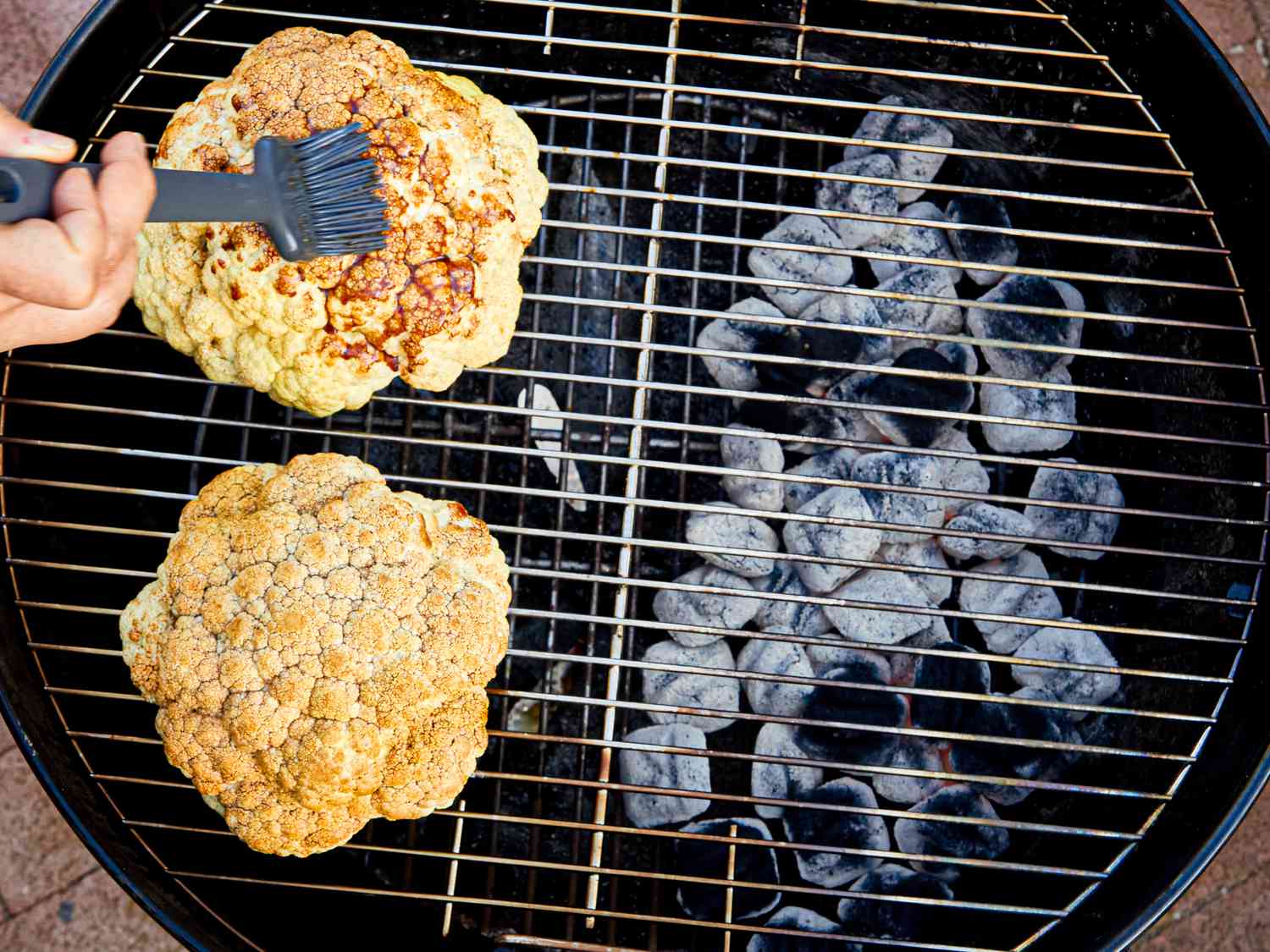 Overhead view of brushing teriyaki on caulifloweer