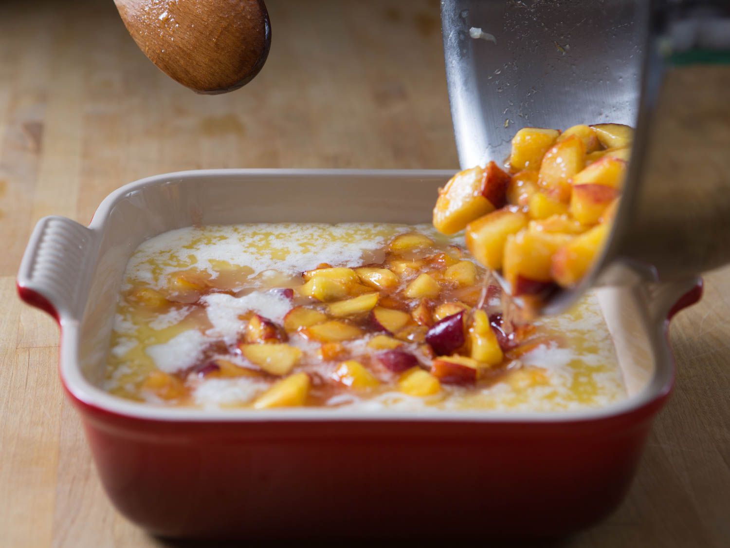 Adding ripe peaches to a dish already filled with batter (not the method used in this recipe.)