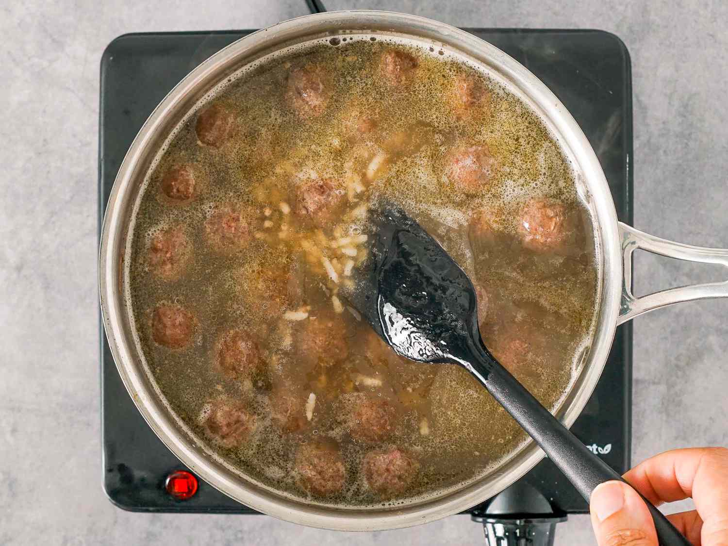 meatballs and rice added to stock
