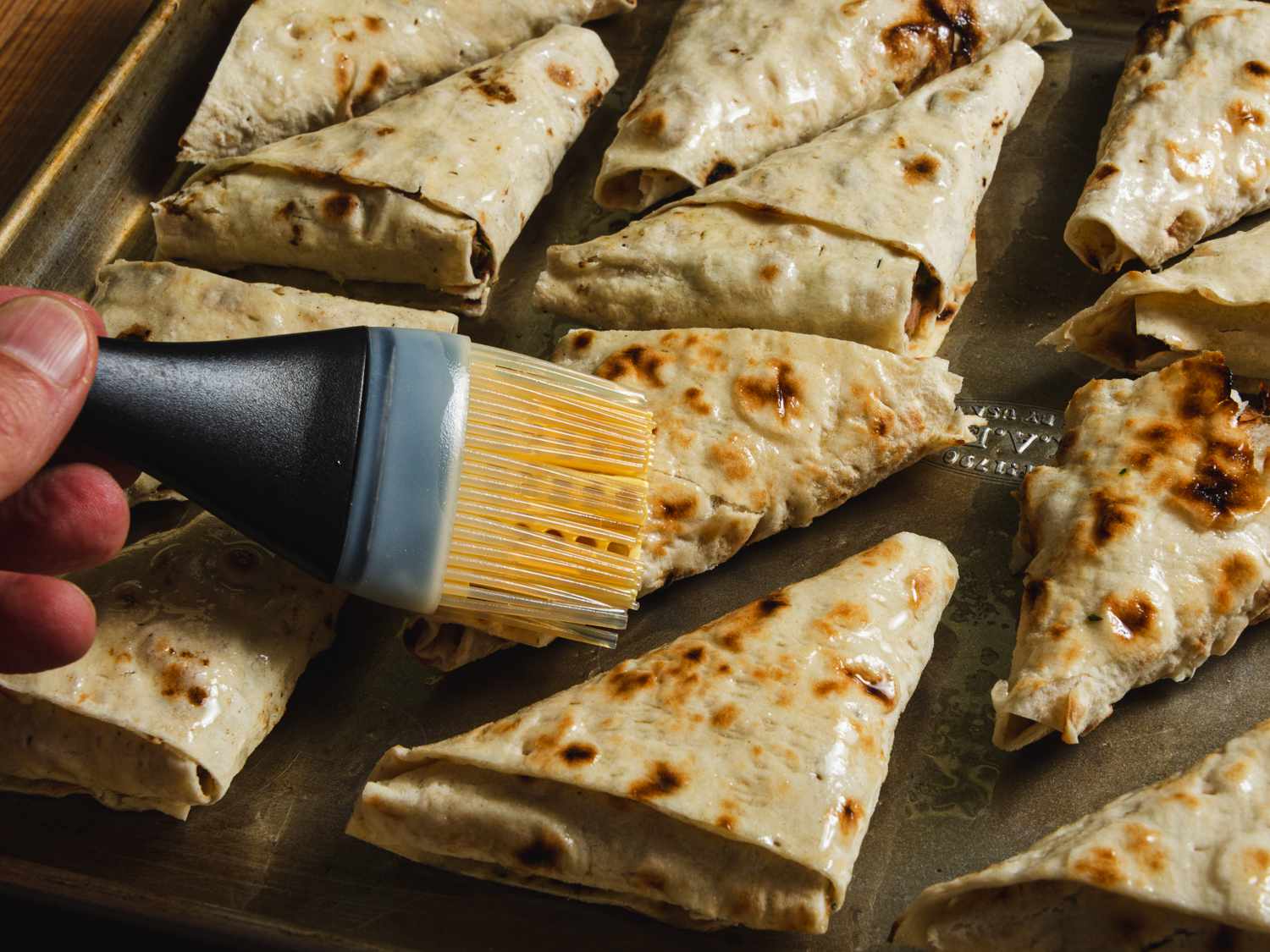 Olive oil-brushed lavash triangles about to bake.
