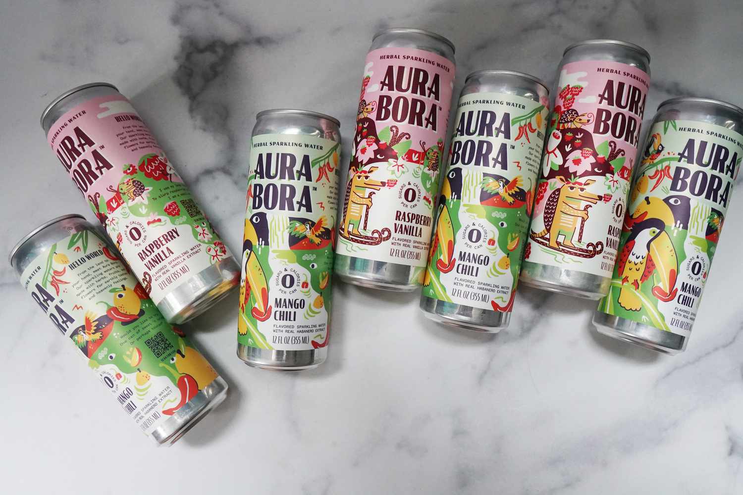 Seven cans of seltzer on a marble surface