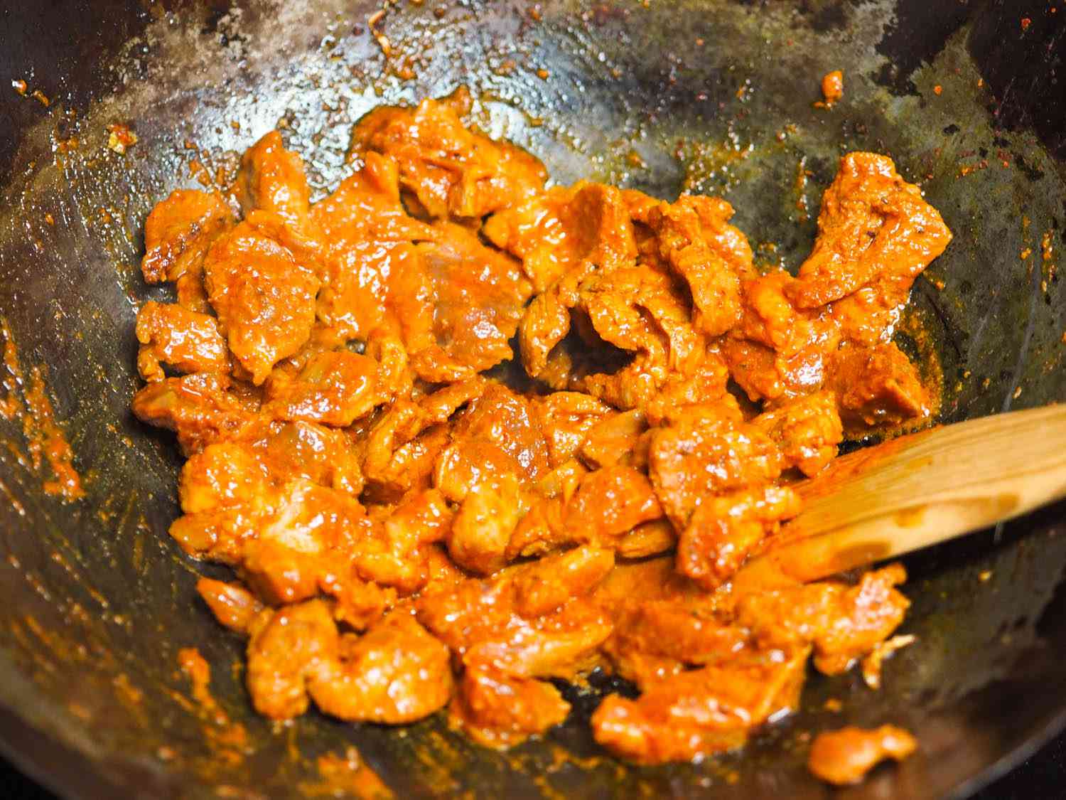 The marinated pork is stir-fried in batches.