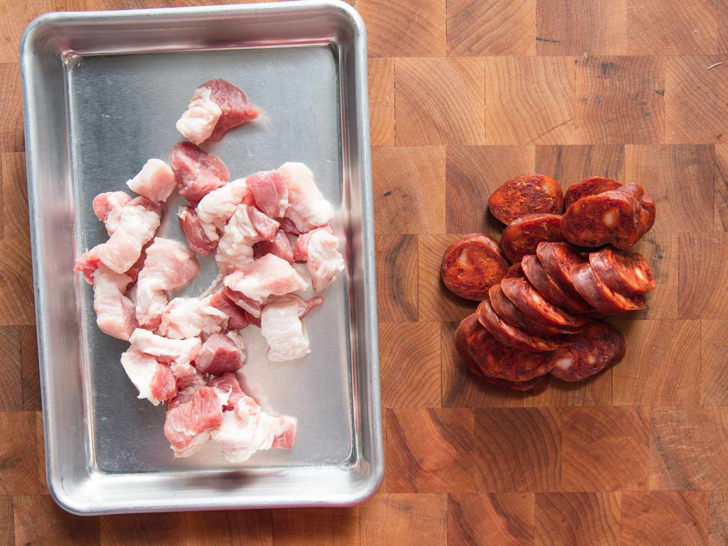 Overhead shot of pork belly and chorizo for migas.