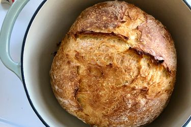 a loaf of sourdough bread in a dutch oven