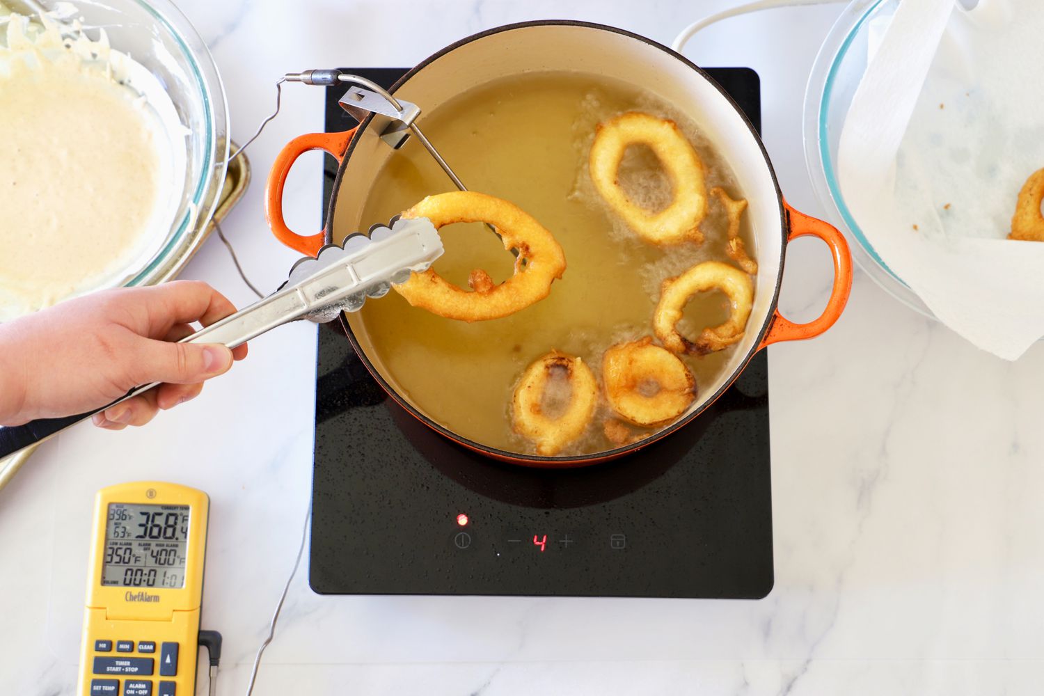 cooking onion rings in a dutch oven on an induction burner