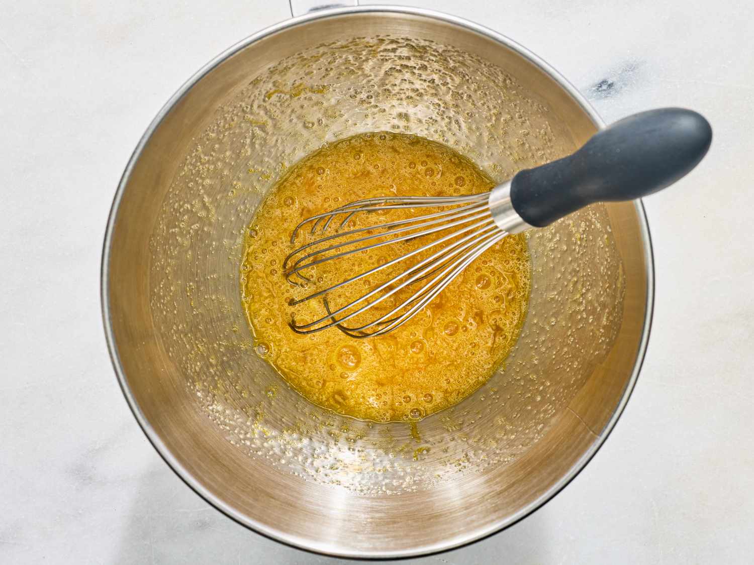 Whisk mixing ingredients in a stainless steel bowl