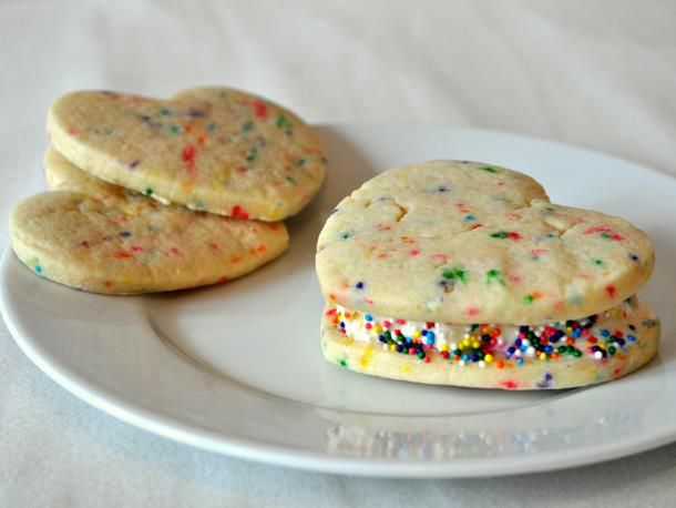 Heart-shaped confetti cookies, served on a plate.