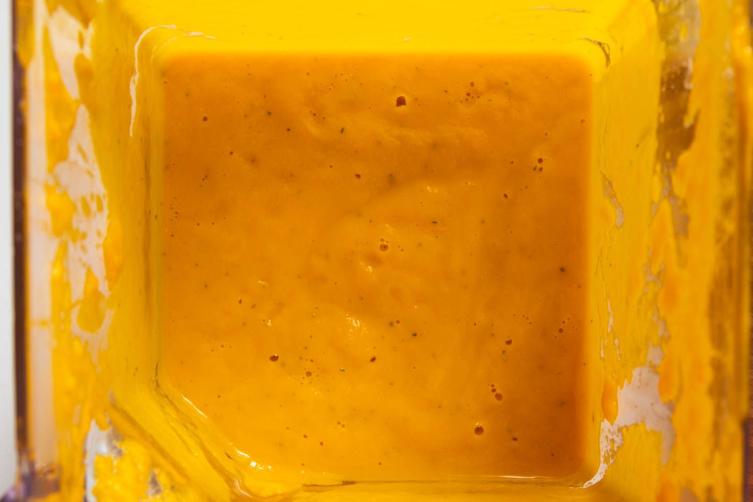 Chilled carrot soup being pureed in blender.