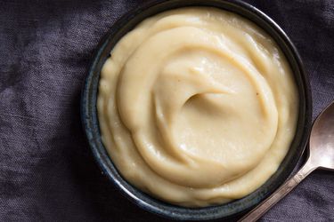 A bowl of homemade creamy banana pudding on a dark background