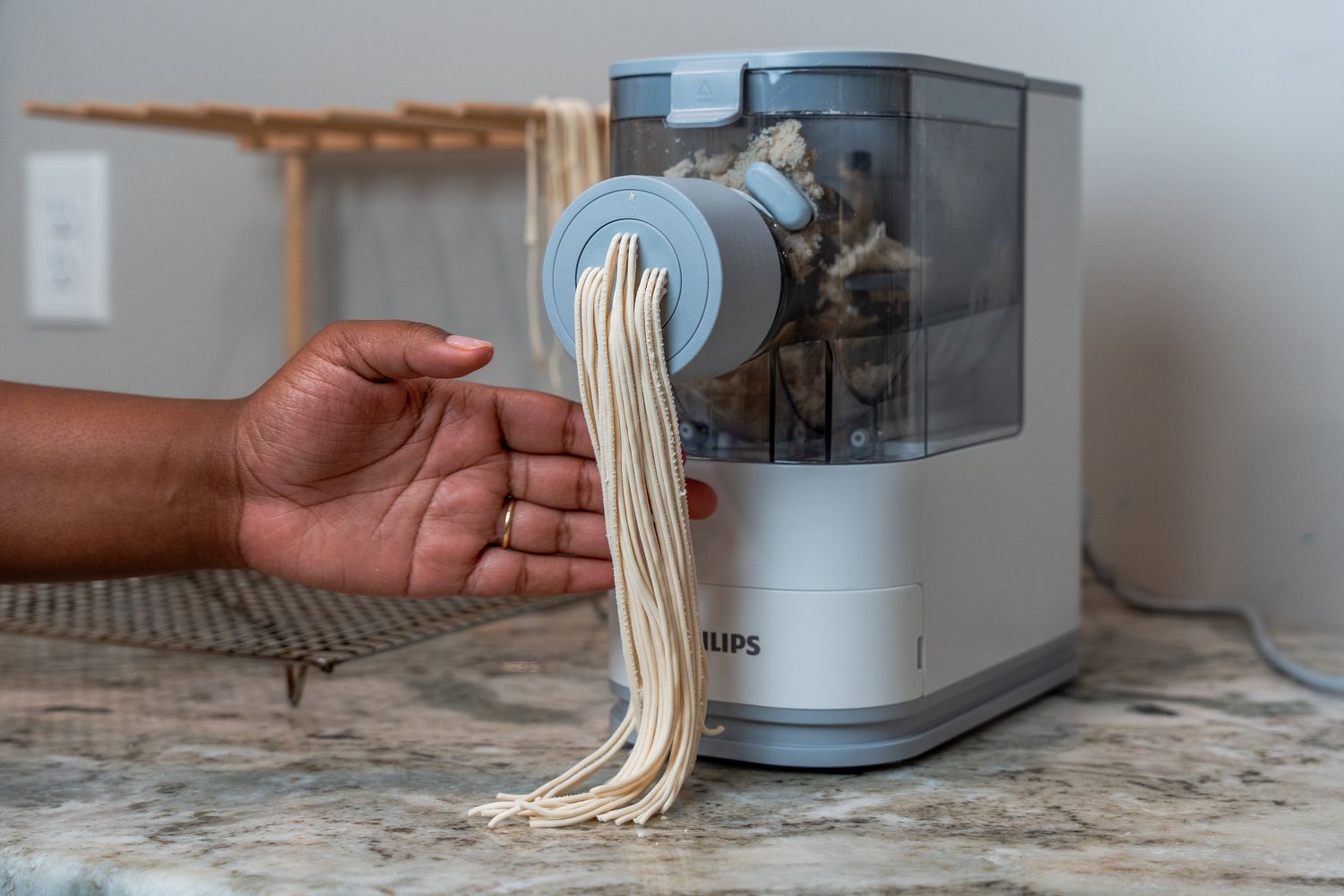 A person making spaghetti with the Philips Viva Collection Pasta and Noodle Maker 