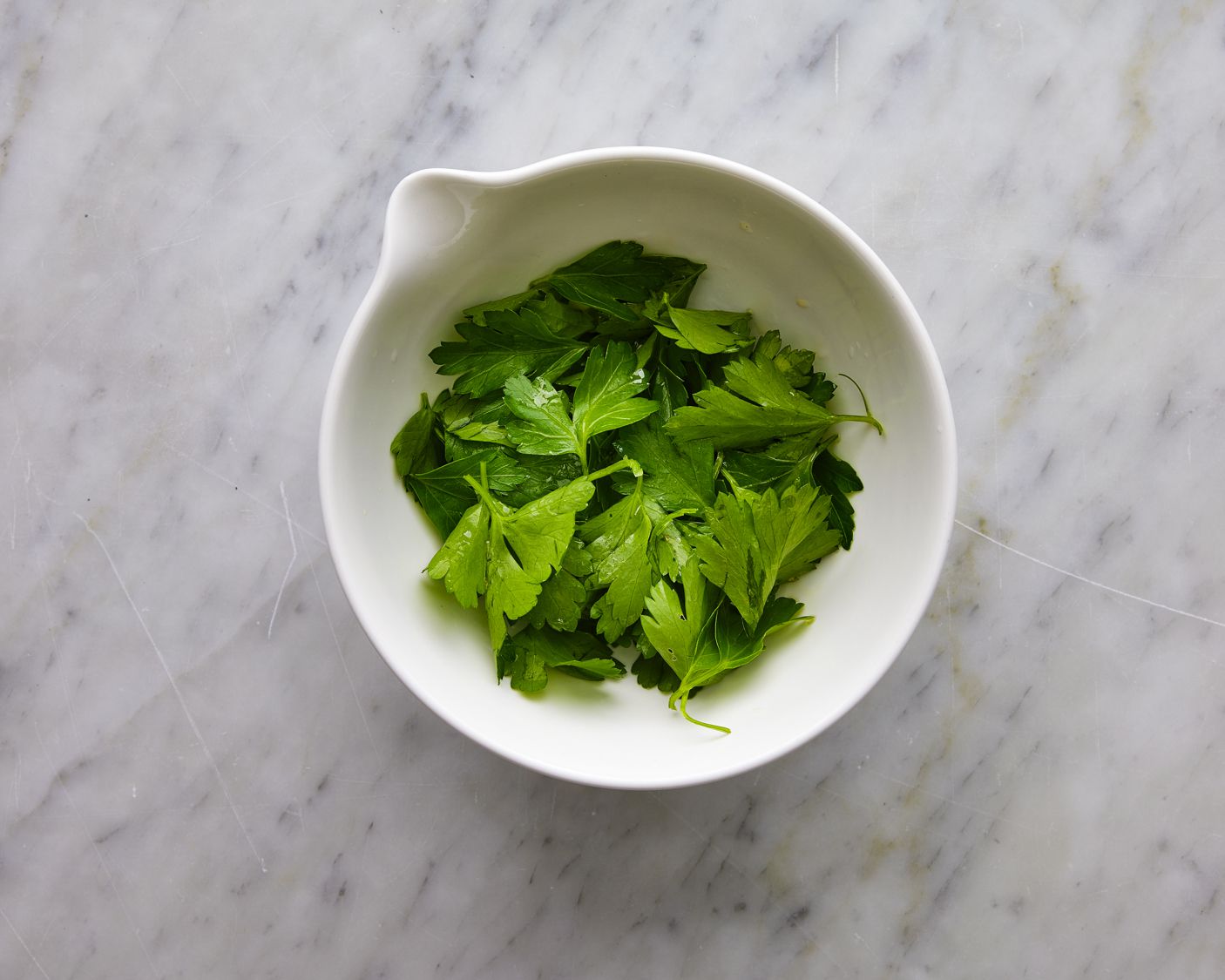 Overhead view of parsley tossed with vingear