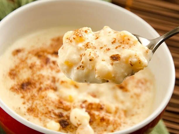 Eating Brazilian canjica de milho with a spoon.