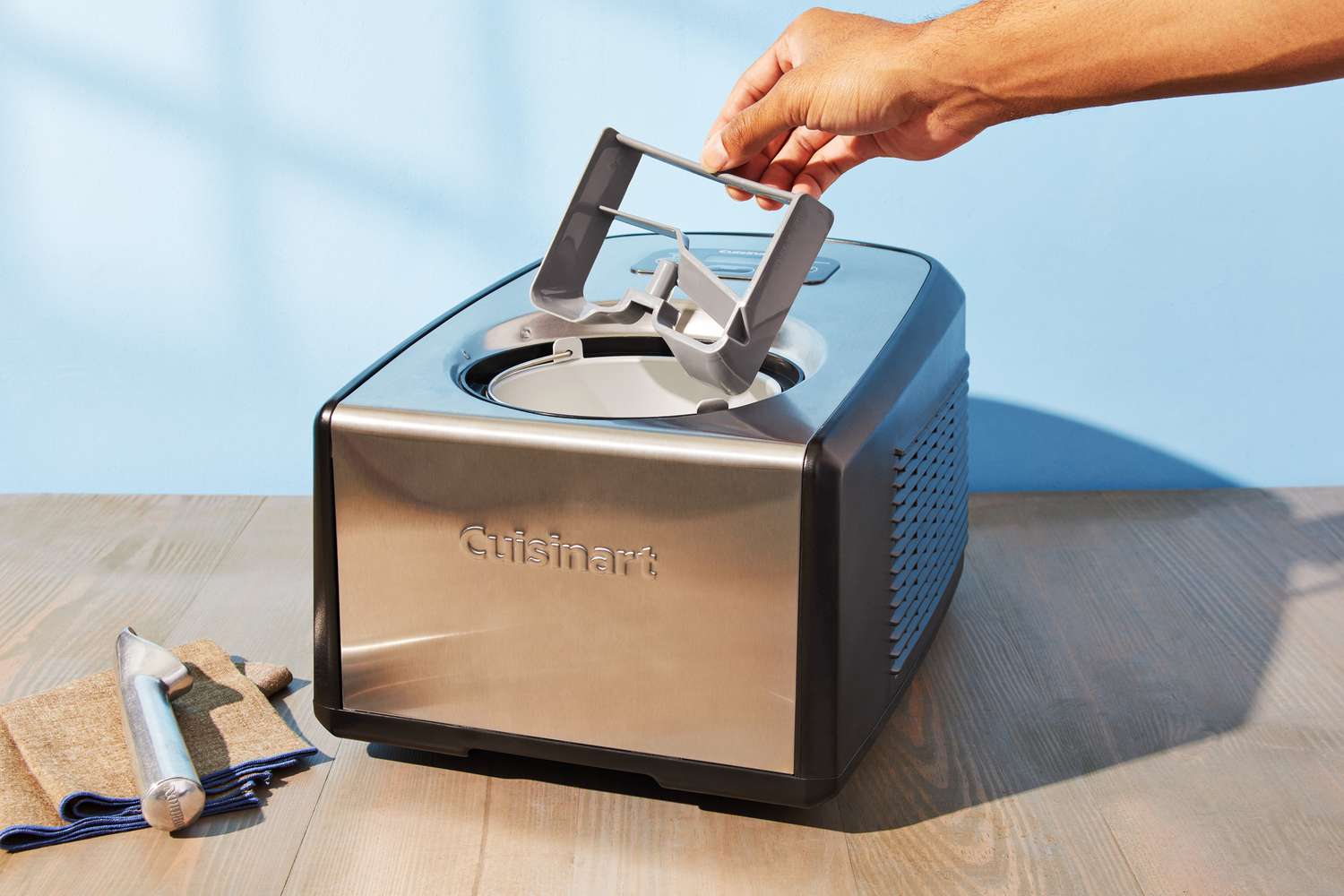 Hand removing the paddle from Cuisinart ICE-100 Compressor Ice Cream and Gelato Maker