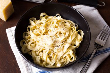 A bowl of fresh homemade pasta with Parmesan.