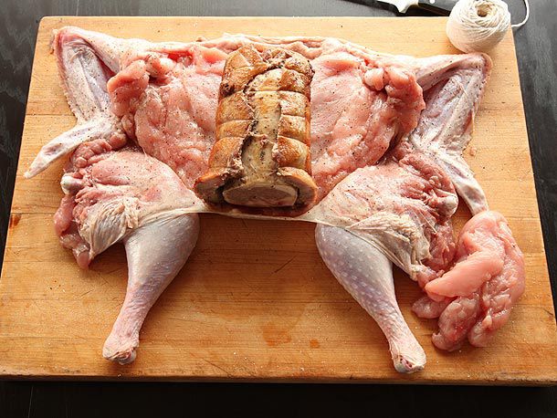 Browned duck/chicken roll centered on butterflied turkey