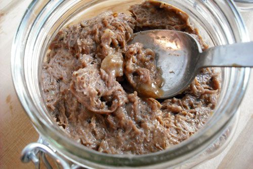 A glass jar filled with rillettes made from turkey gizzards