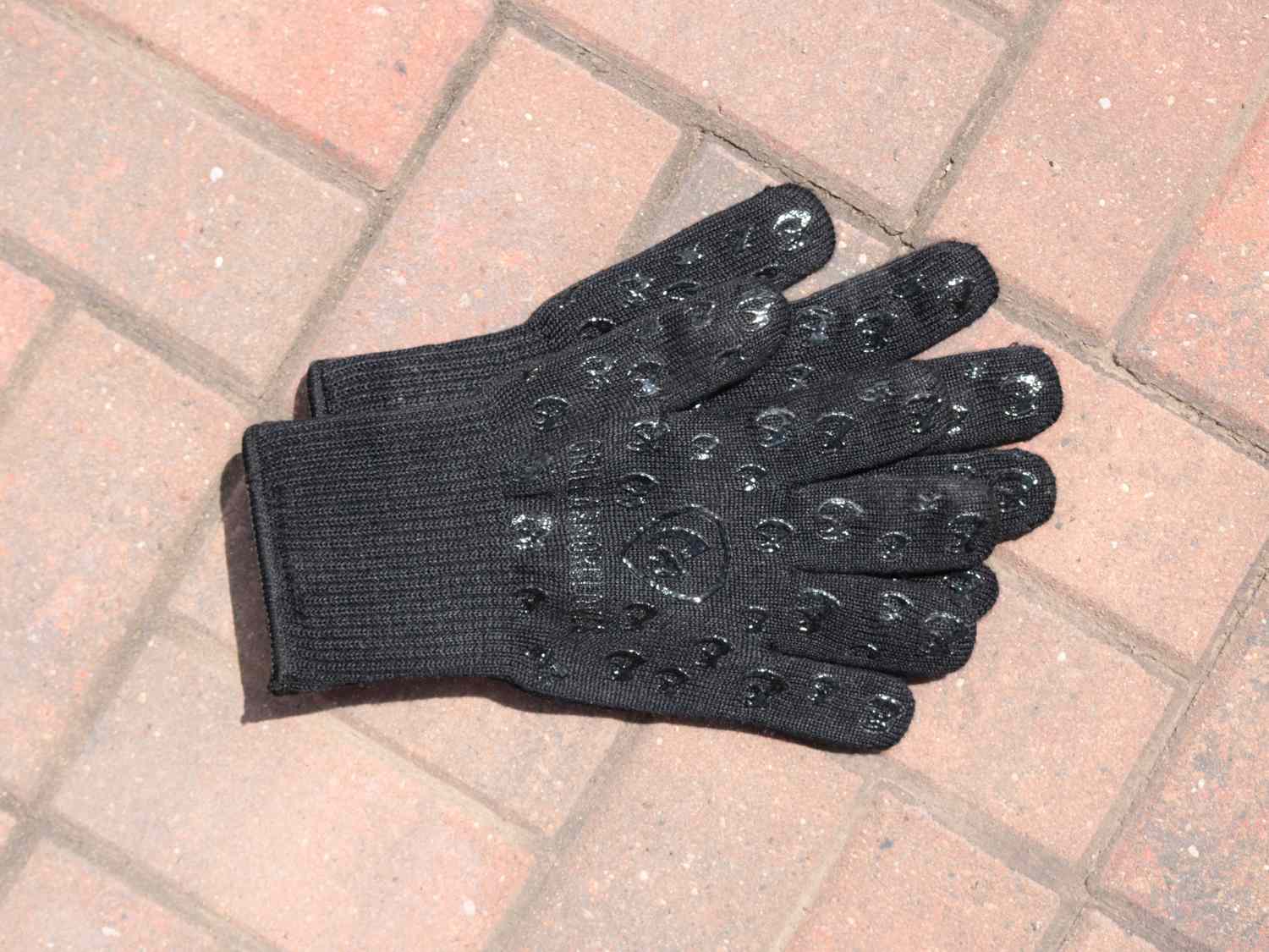 a pair of grill armor grill gloves on a brick background
