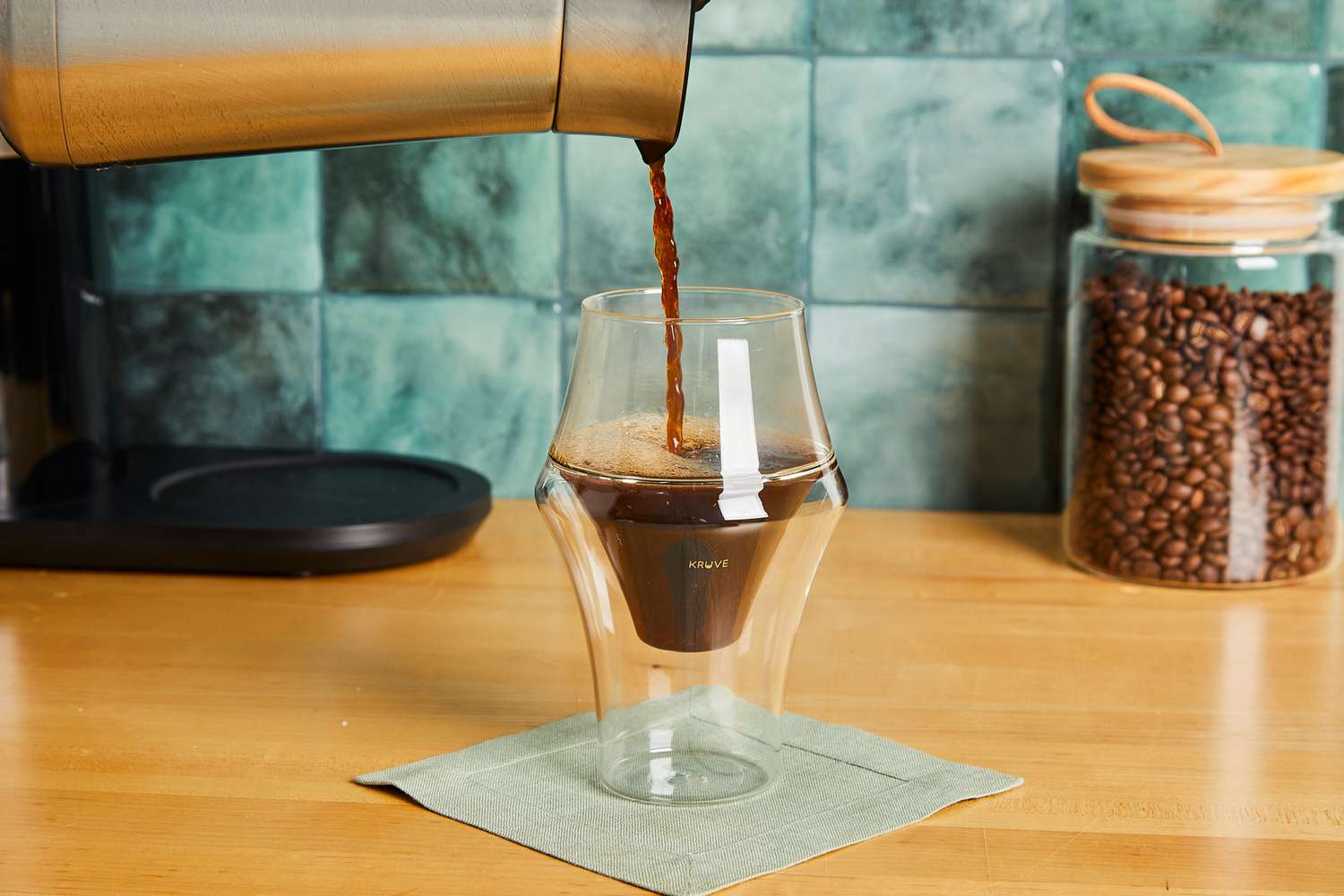 Coffee being poured into a Kruve coffee cup.