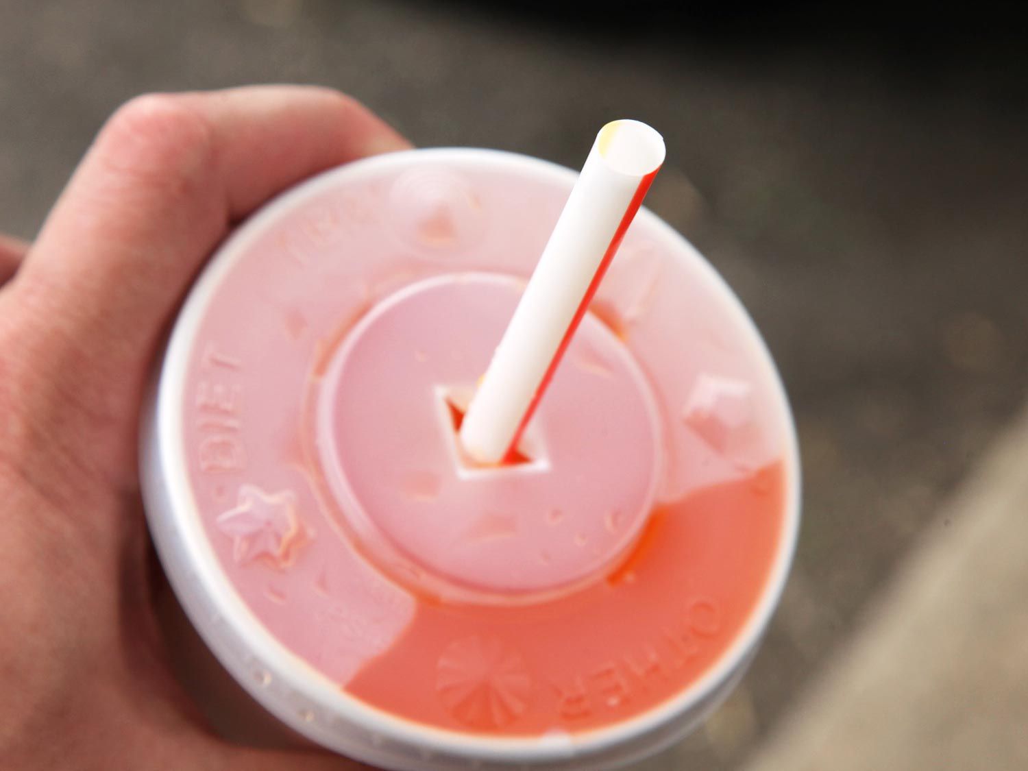 a soft drink from McDonald's with a straw in the lid 