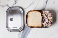 Black+Blum Stainless Steel Lunch Box with food in it on counter