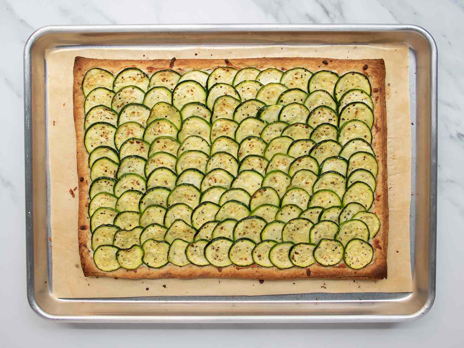 Baked zucchini tart in a rimmed baking sheet