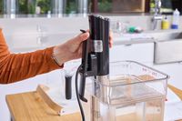 A person presses the clamp on the Instant Accu Slim Sous Vide Immersion Circulator