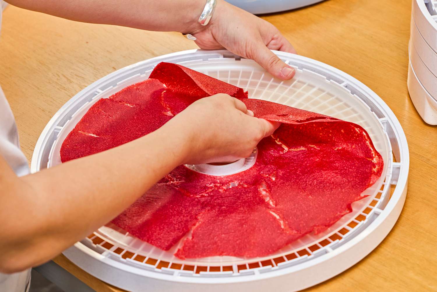 A person removing food leather from a tray