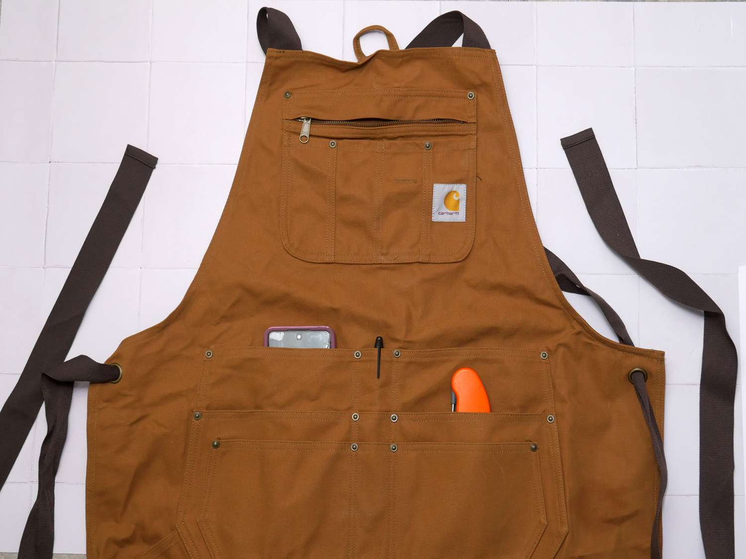 the carhartt apron on a white tile surface