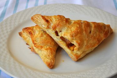 Two easy peach turnovers, served on a white plate.