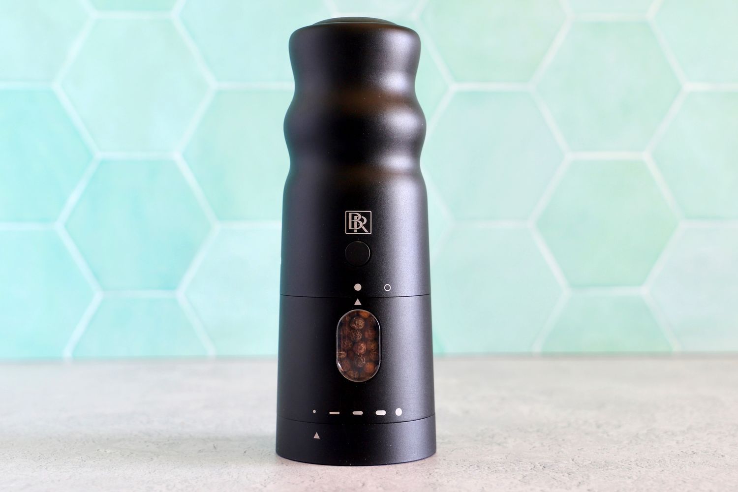the black rain pepper mill filled with pepper