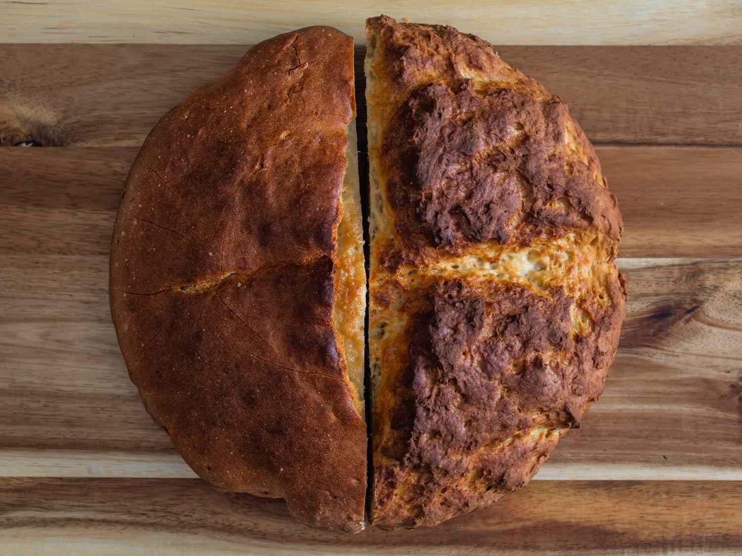 Side by side comparison of Irish soda bread half-loaves, smoother crust on left and rougher crust on the right 