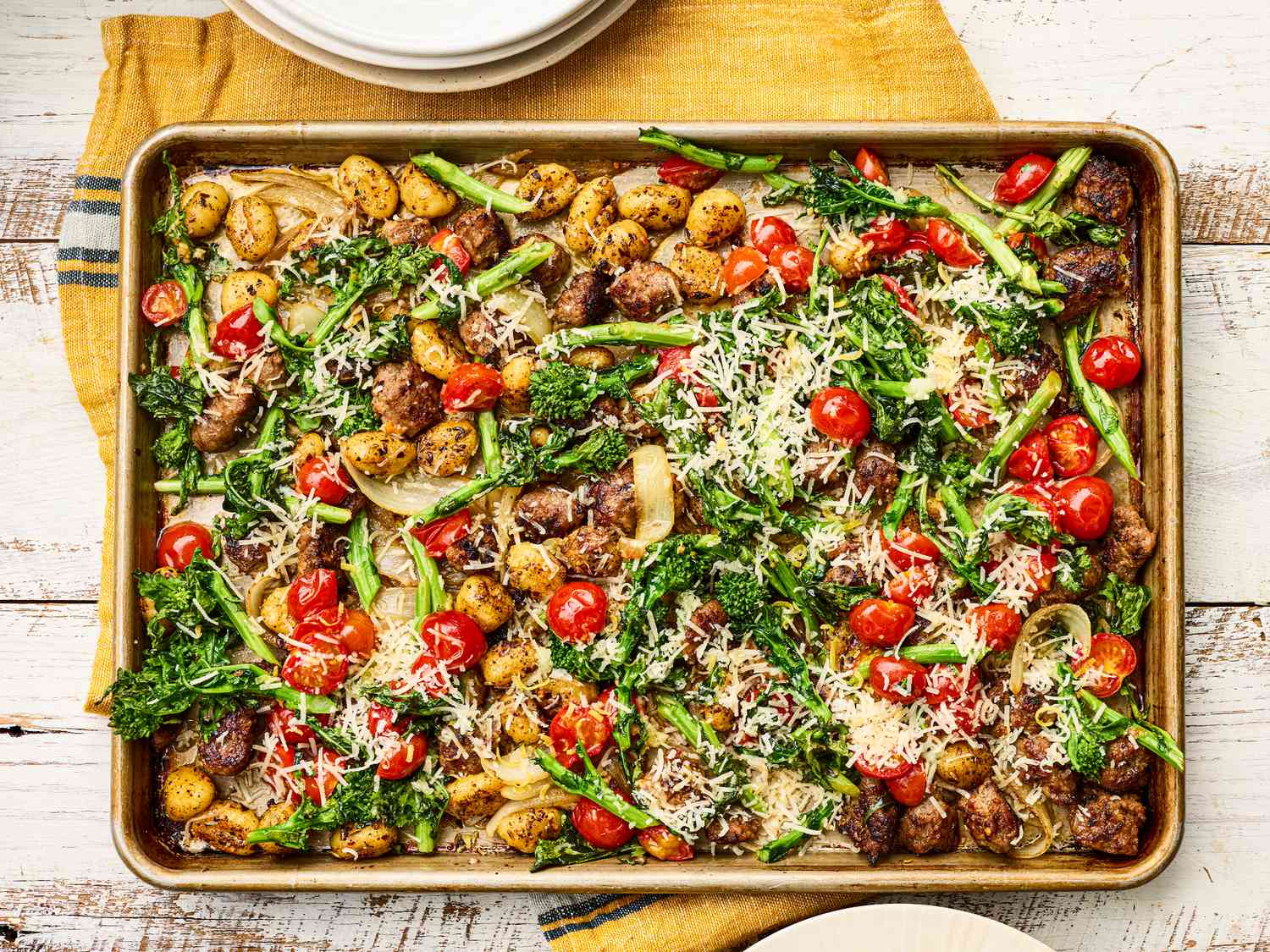 Sheet pan meal with gnocchi, vegetables, and grated cheese