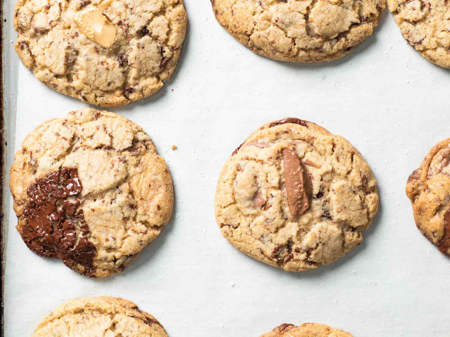 Overhead closeup of the finished cookies on a parchment-lined baking sheet, fresh from the oven.
