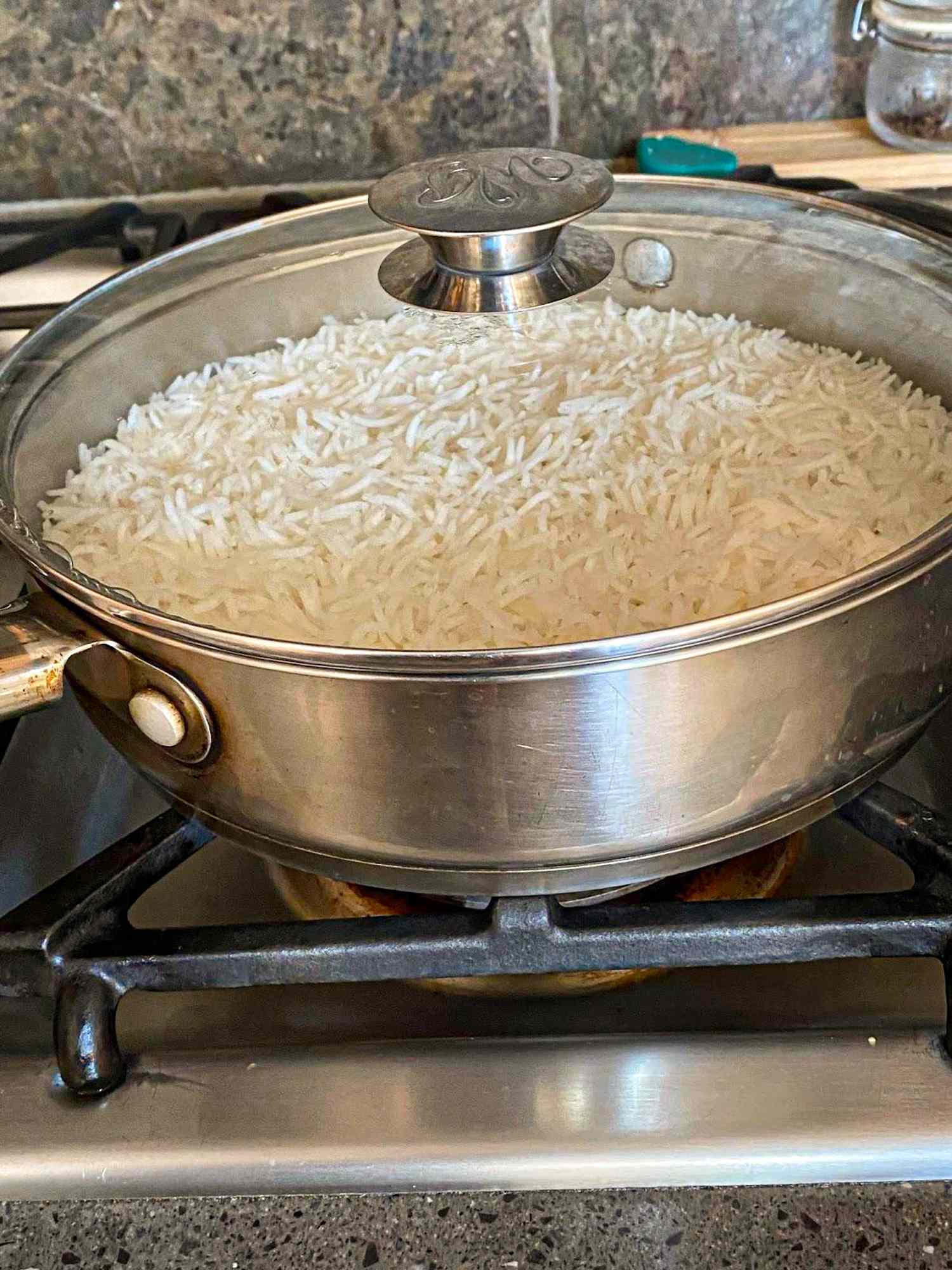 A pot of cooked rice on a stovetop
