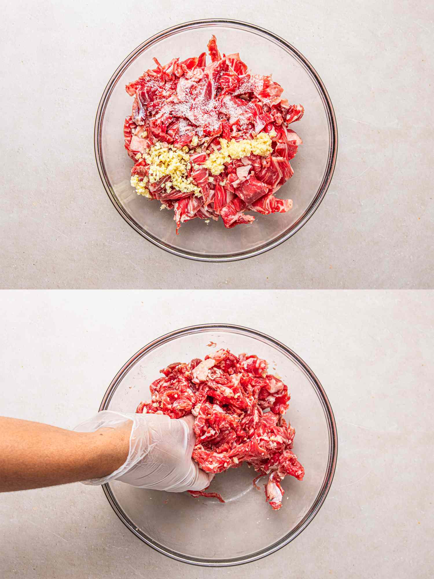 Marinated beef in a bowl being mixed by a gloved hand showing preparation for a recipe