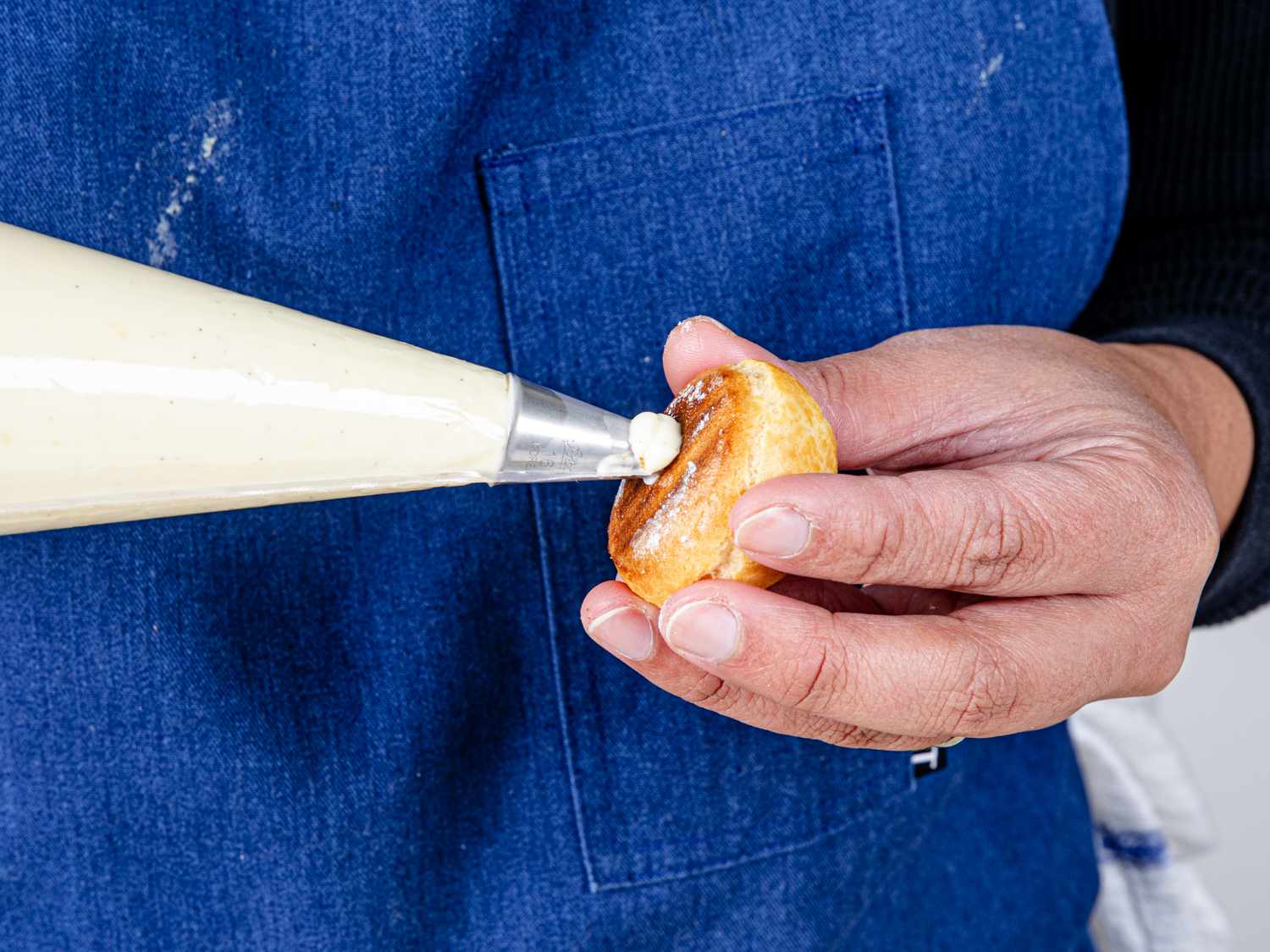 Close up of filling a puff with cream