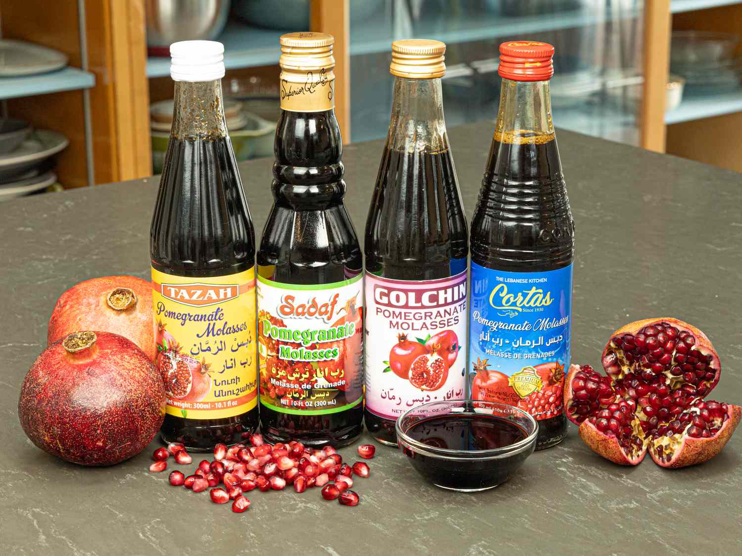 Fessenjan-NaderMehravari-hdedenote-bottles of pomegranate molasses