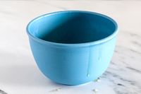 A Bamboozle mixing bowl on a countertop with liquid dripping from its side