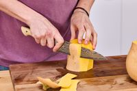 A person slices a butternut squash using the Zwilling Kanren 8 Inch Chef's Knife