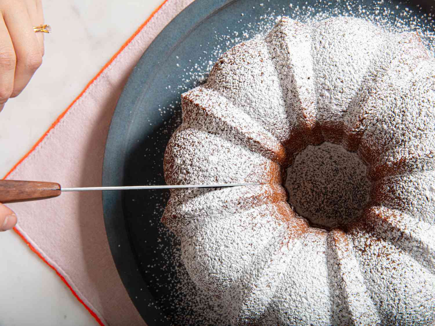 Overhead view of cutting cake