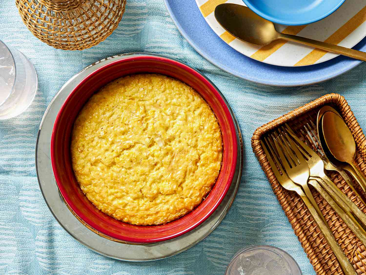 Corn pudding in a red baking dish.