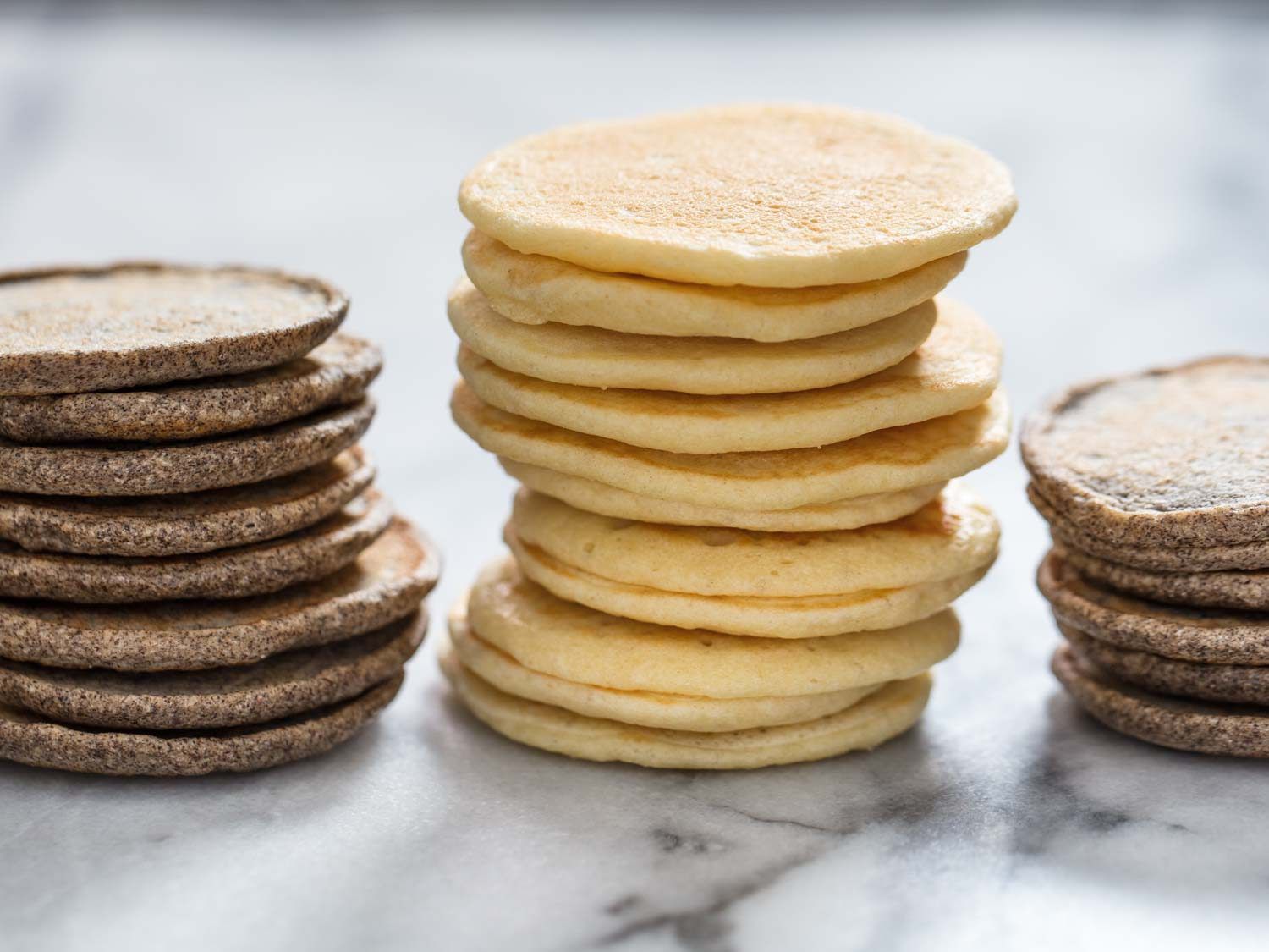 Side view of stacks of buckwheat and yeasted blini
