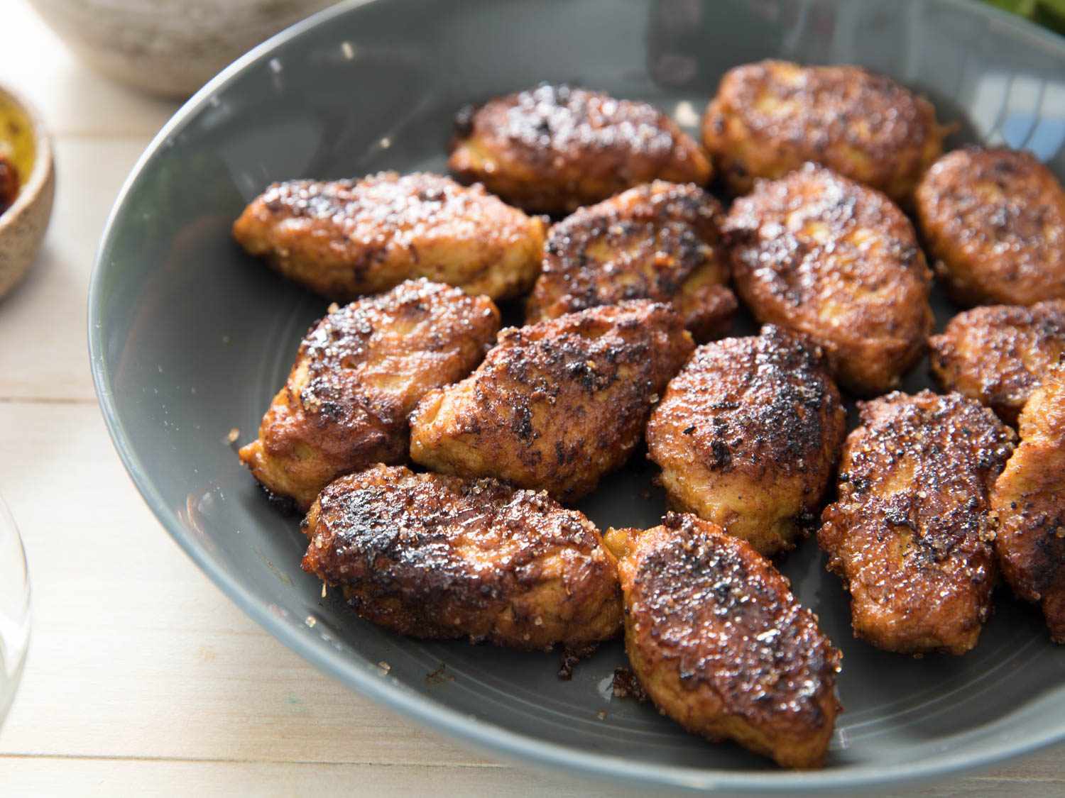 Closeup of the finished meatballs, served in a large, shallow gray bowl.