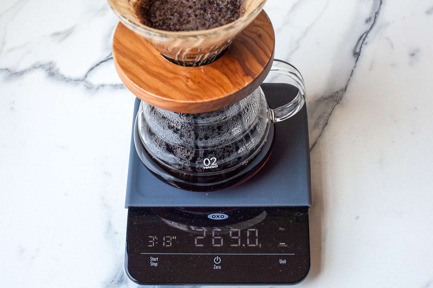 A coffee brewing setup on a digital scale showing weight measurement