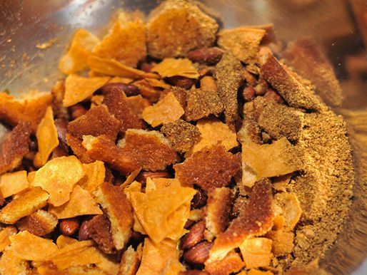 Fried bread and tortillas broken into small pieces and transfer to bowl with a spice mixture.