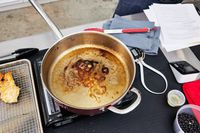 Williams Sonoma Thermo-Clad Copper 10-Piece Cookware Set pan on burner with cooked oil inside